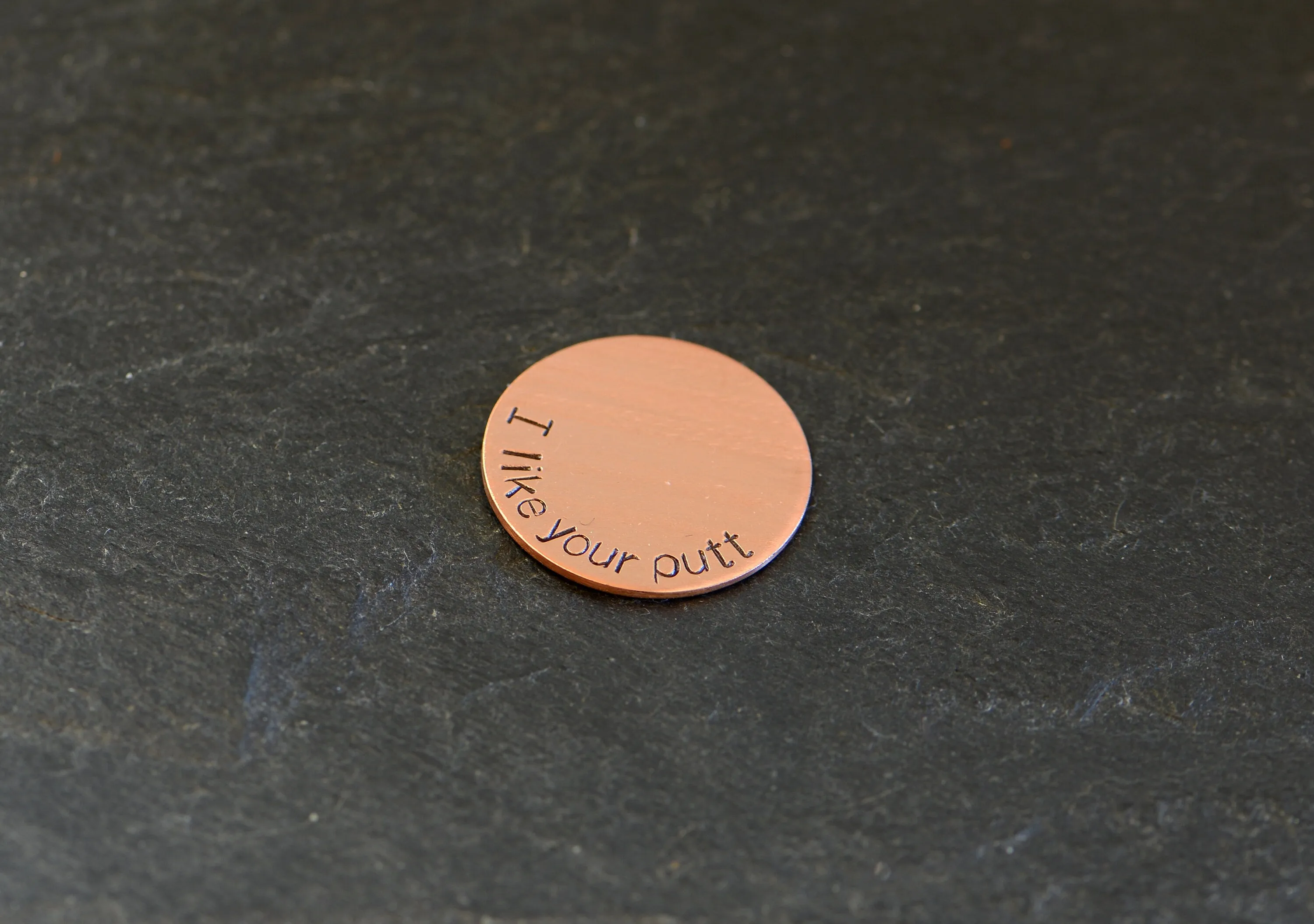 Copper golf ball marker with I like your putt