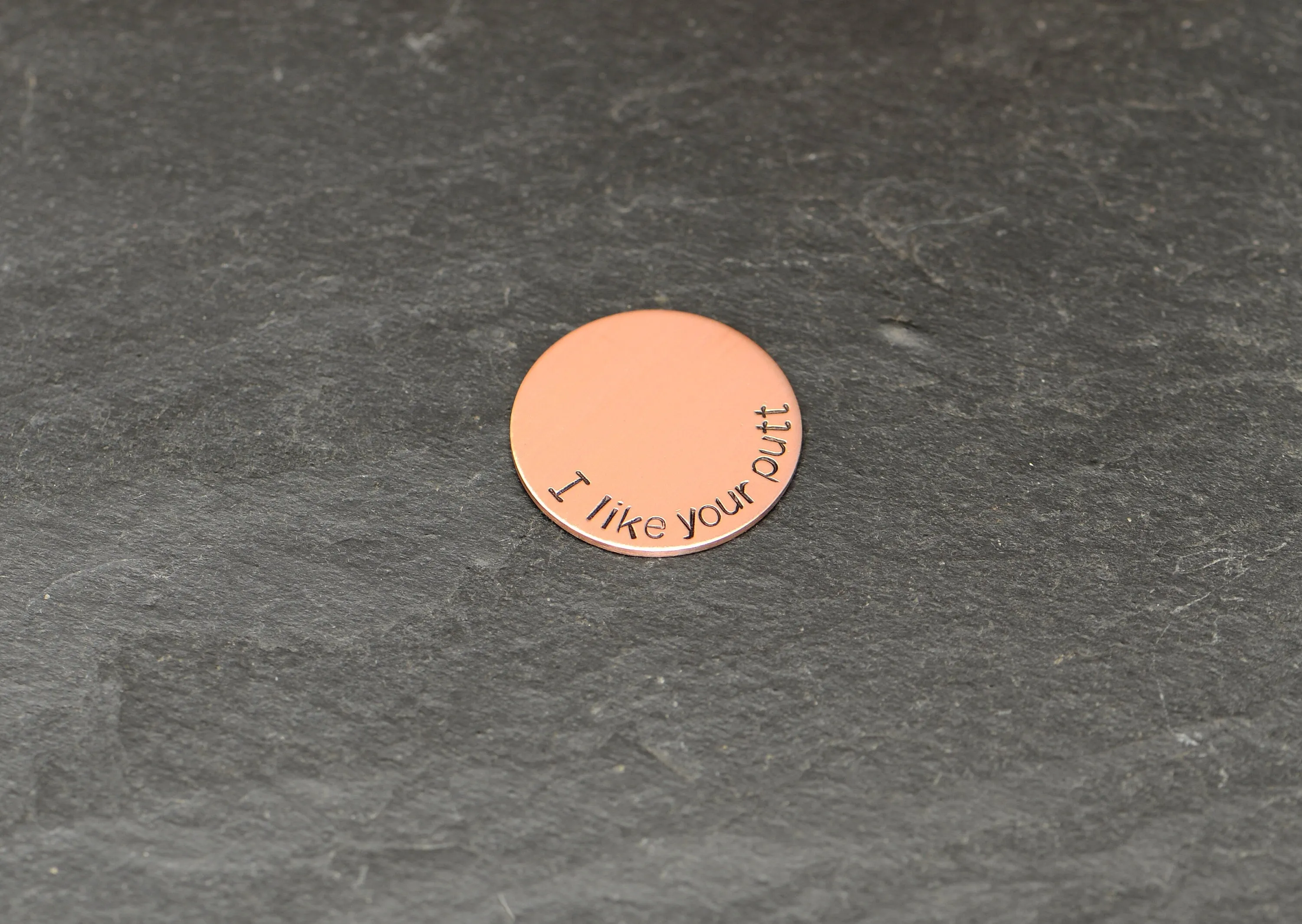 Copper golf ball marker with I like your putt